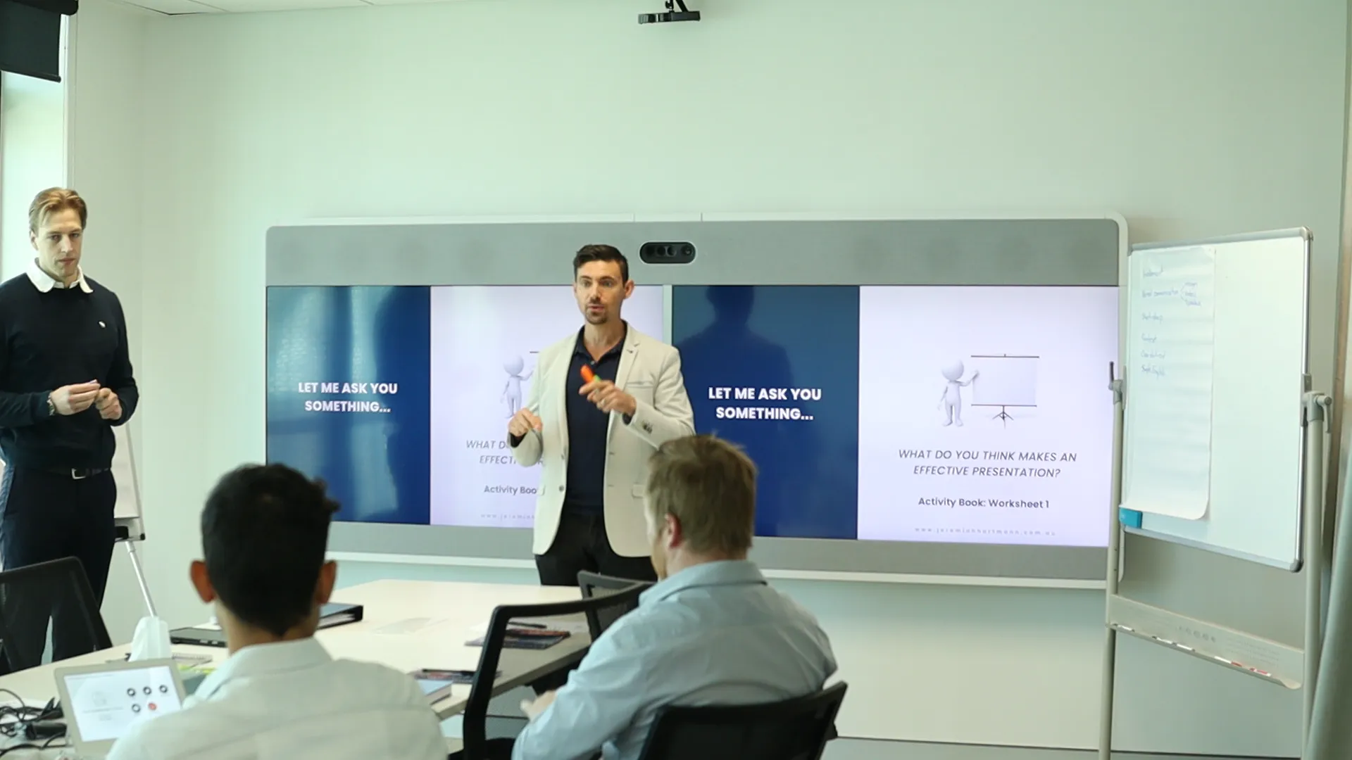 Jeremiah Hartmann facilitating a communication training session in a meeting room